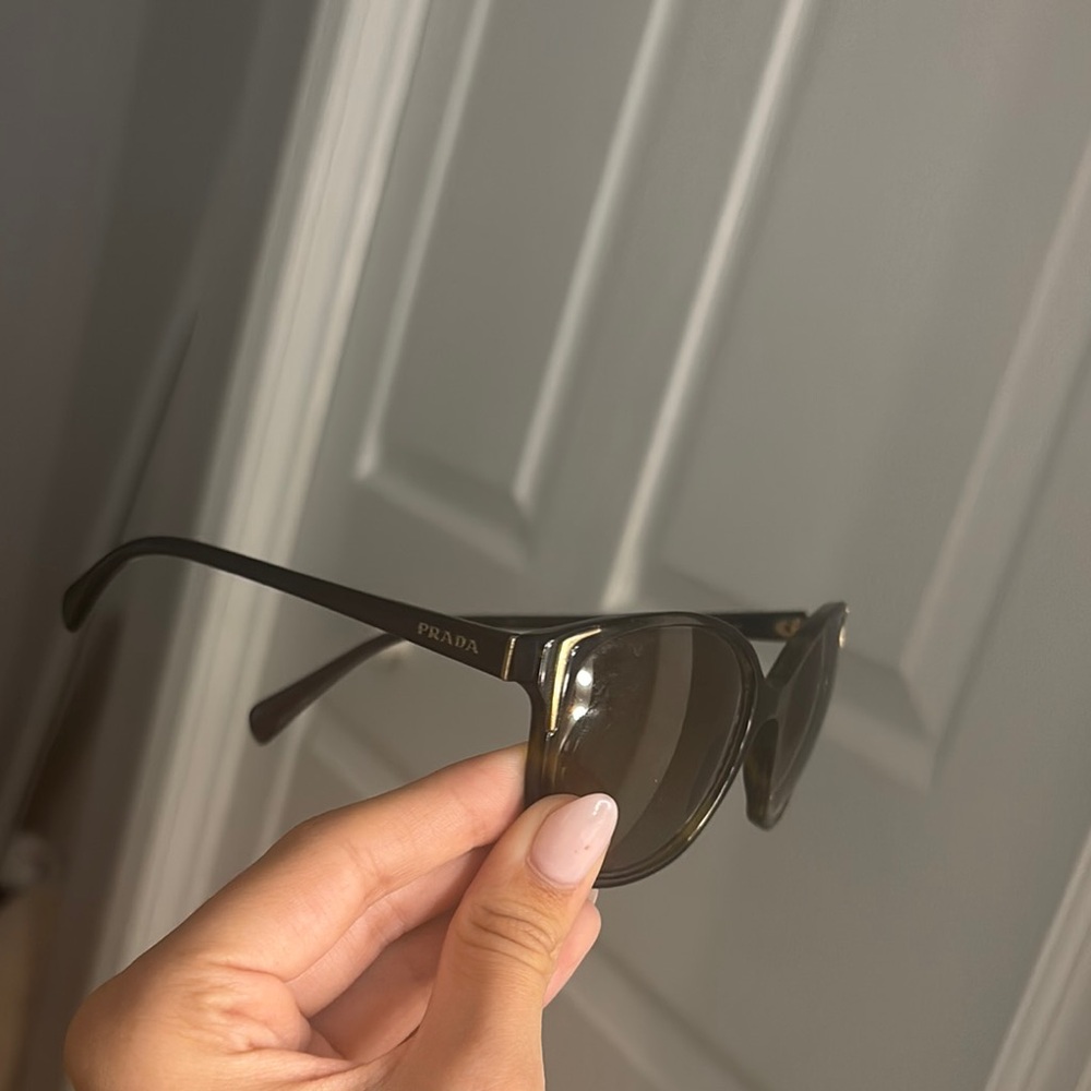 Prada Dark Sunglasses with Gold Accents